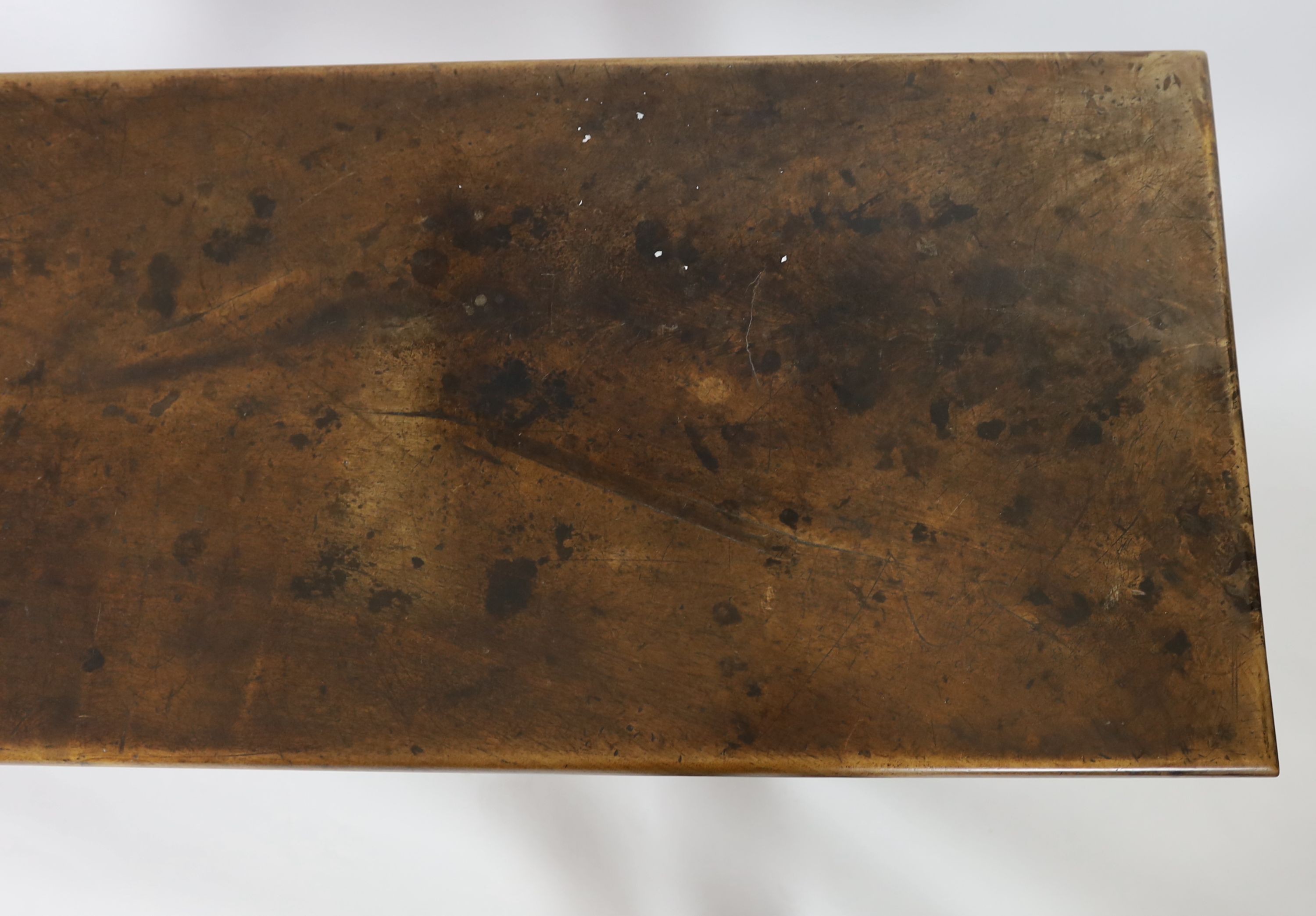 An 18th century walnut refectory table, W.232cm D.59cm H.82cm